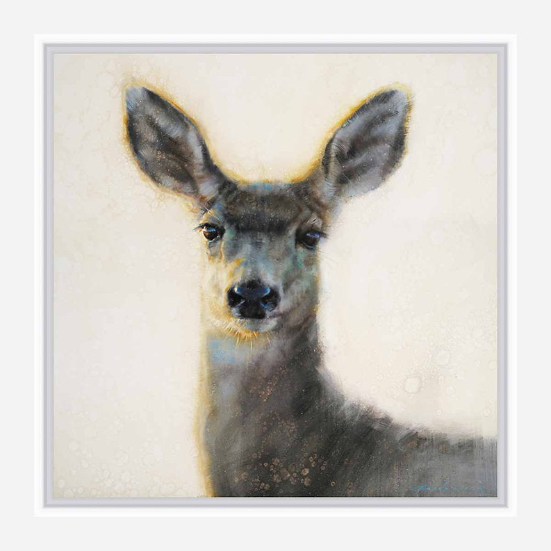 Framed artwork of a deer's face on a light background