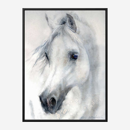 Black framed artwork of a white horse's head on a light background