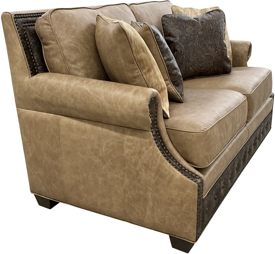 Side view of the El Dorado Loveseat highlighting its curved rolled arms, smooth leather upholstery, and expert craftsmanship for a luxurious seating experience.