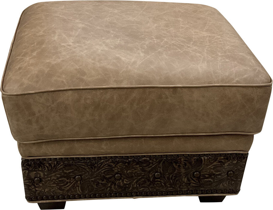 A top-down view of the El Dorado Ottoman, showcasing its smooth Palio Camel leather cushion with subtle natural textures and elegant piping along the edges.
