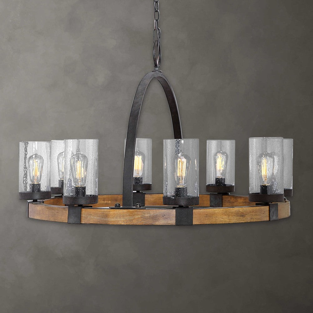 Industrial wagon wheel chandelier with sturdy wooden frame, iron-wrapped frame in deep bronze, and eight Edison bulb sockets.