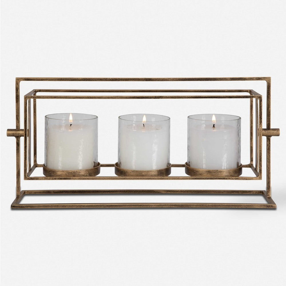 Elegant three-candle lantern featuring a removable glass hurricane design, antique gold iron stand, and three white pillar candles.