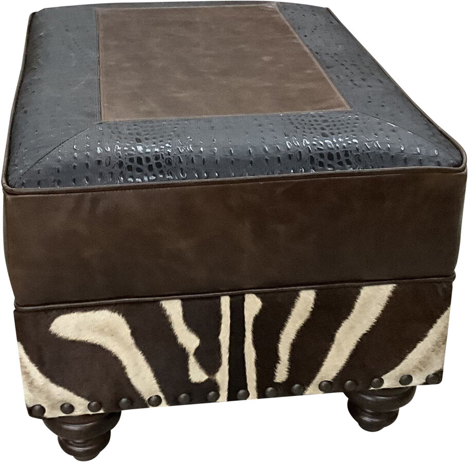 Side profile of the Exotic Zebra Ottoman, highlighting the intricate Walkabout Croc Vintage Black leather inserts and expertly crafted design.