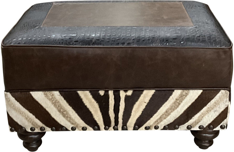 Exotic Zebra Ottoman, featuring rich Kodiak Bear leather, Walkabout Croc Vintage Black accents, and a striking zebra hide on the bottom rail.