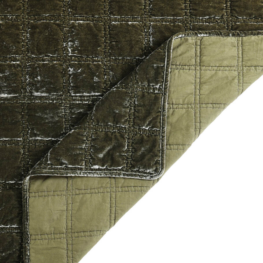 Close-up of the quilt's corner, displaying the precise stitching and plush velvet texture in a calming fern green shade.