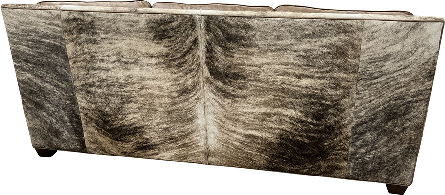 The back view of the Frio River Sofa, featuring luxurious light exotic brindle cowhide upholstery, highlighting its unique Western design and high-quality craftsmanship.