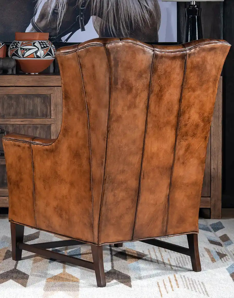 Rear image showcasing the smooth leather finish and the elegant curvature of the chair’s wingback design.