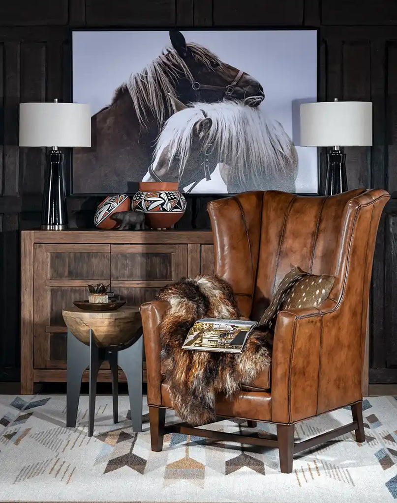 The Ganesha Leather Chair styled in a warm, rustic living room, complementing the refined décor.