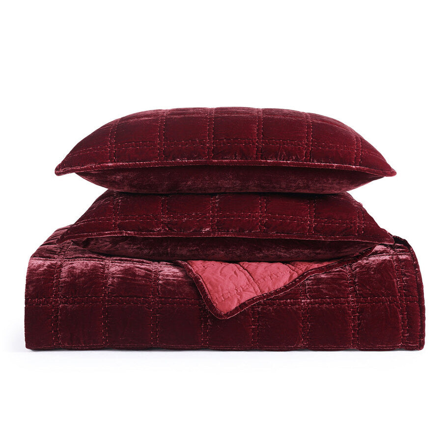 Garnet Red Faux Silk Velvet Quilt Set displayed with coordinating pillow shams, highlighting the cohesive design and elegant stitching.
