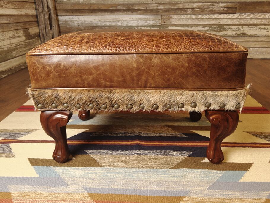 Front view of the Giovanni Small Ottoman, upholstered in Giovanni Light Brown leather with embossed Gator Rustic Cognac accents and exotic cowhide trim.