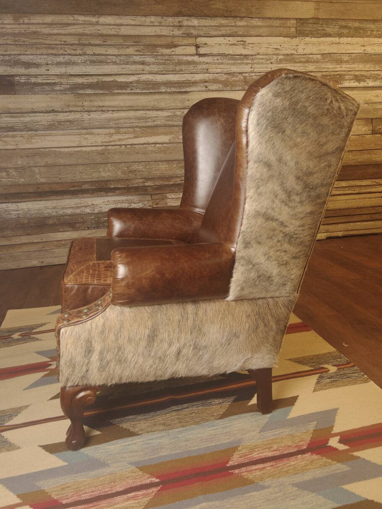 Side profile of the Giovanni Wingback Chair displaying the elegant curvature of the armrests and the detailed craftsmanship of the embossed leather accents.