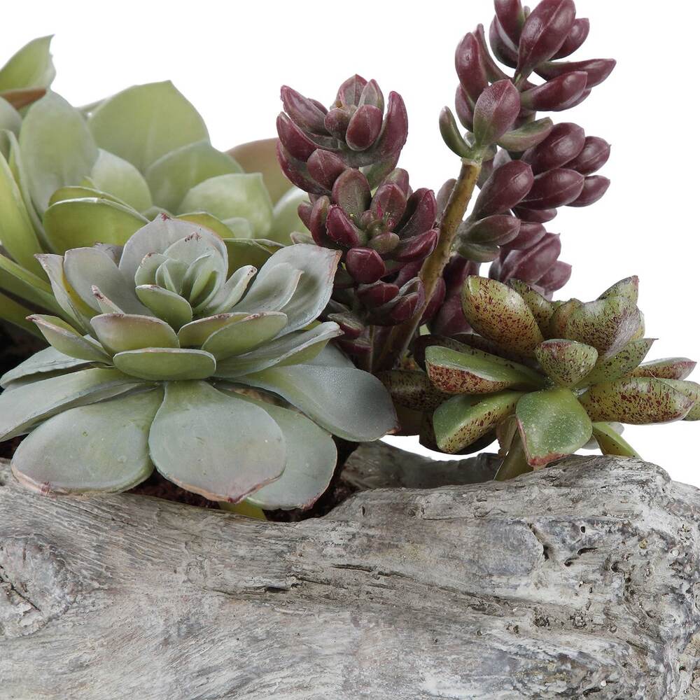 Rustic artificial succulent display featuring a driftwood-style container and realistic faux soil.