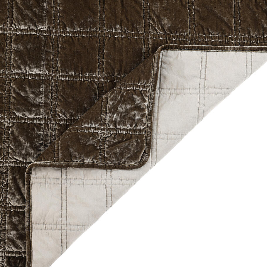 Close-up of the quilt's corner, displaying the precise stitching and plush velvet texture in a soothing green ochre shade.