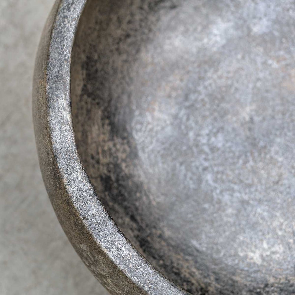 Handcrafted aged black terracotta bowl featuring a distressed finish, adding a touch of rustic charm to your living room or kitchen decor.