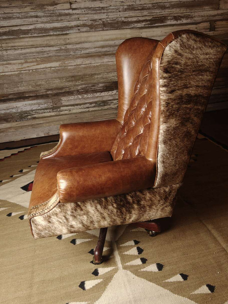 Side profile of the Honcho Executive Chair highlighting the ergonomic design and cowhide detailing on the chair's exterior.