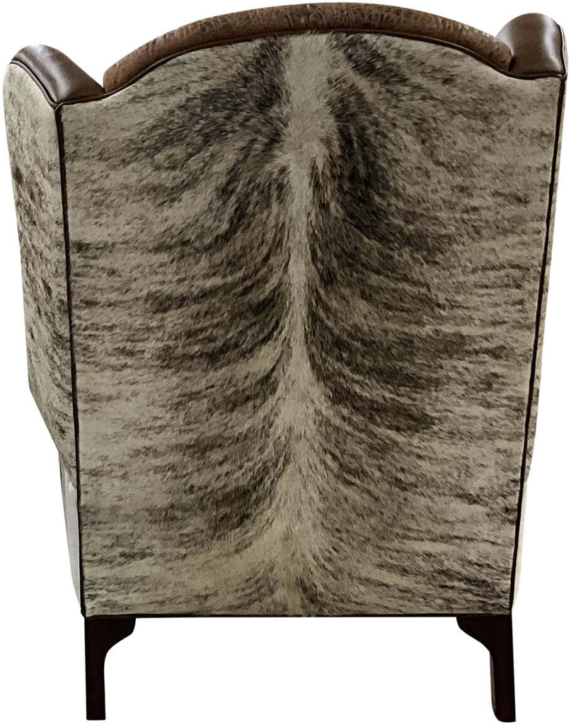 Rear view of the Honcho Wingback Chair featuring a full light exotic brindled cowhide covering for a striking Western aesthetic.