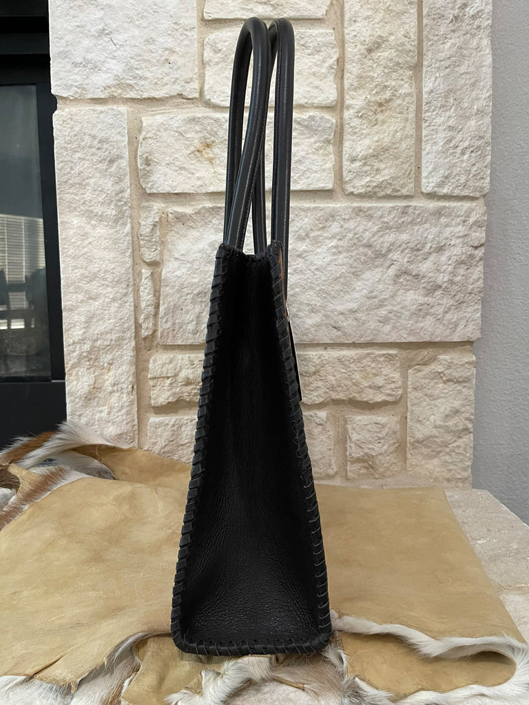 Brown side of bag with with a stone wall background