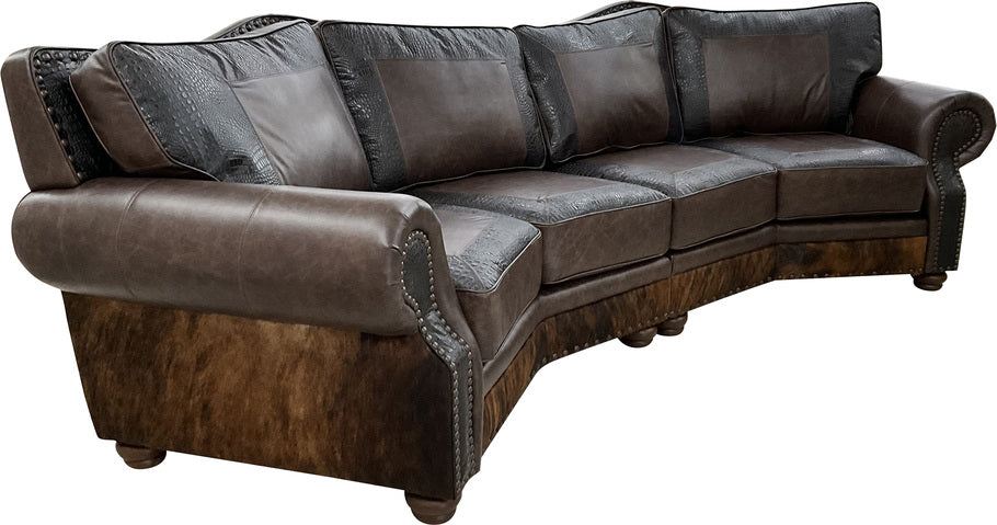 Side view of the Kings Canyon Curved Sectional showcasing its curved design, dark exotic brindle cowhide exterior, and hand-applied distressed bronze nailhead trim.