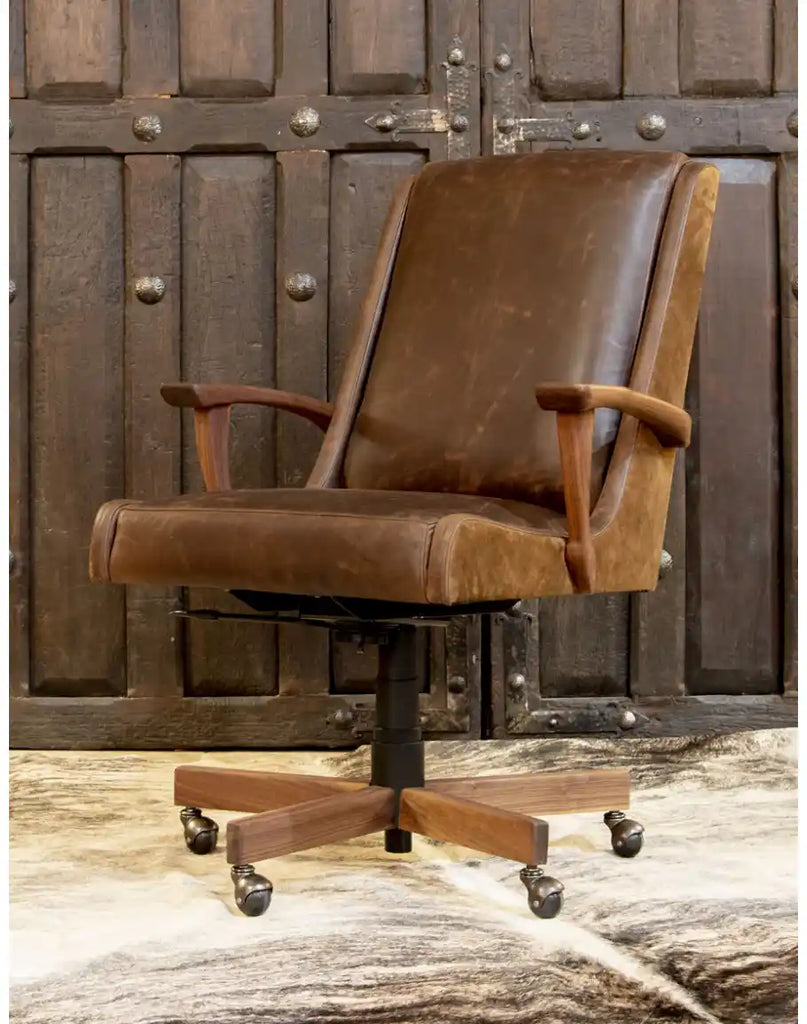 Side profile highlighting the chair's ergonomic design, armrest detailing, and the combination of leather and suede materials.