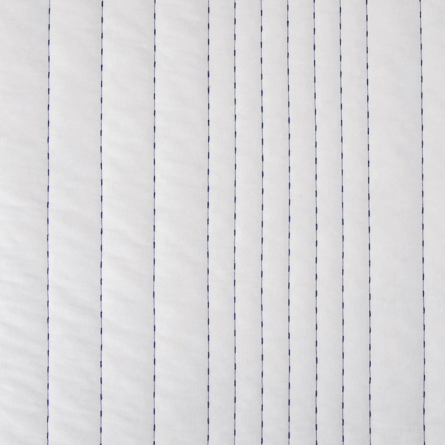 Detailed view showcasing the pristine white reverse side of the Legato Quilt, featuring delicate stitching that adds texture and elegance.​