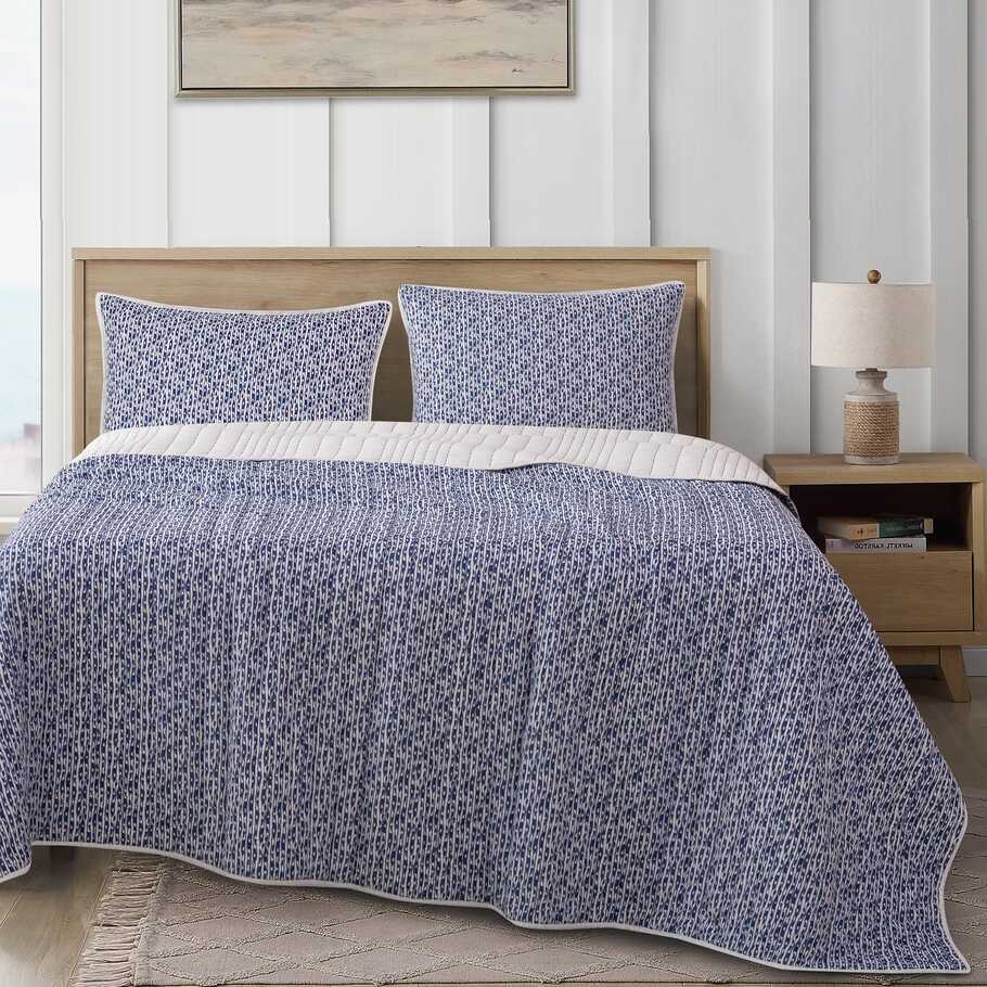 Legato Reversible Quilt Set displayed with matching pillow shams, highlighting the cohesive design and serene color palette.​
