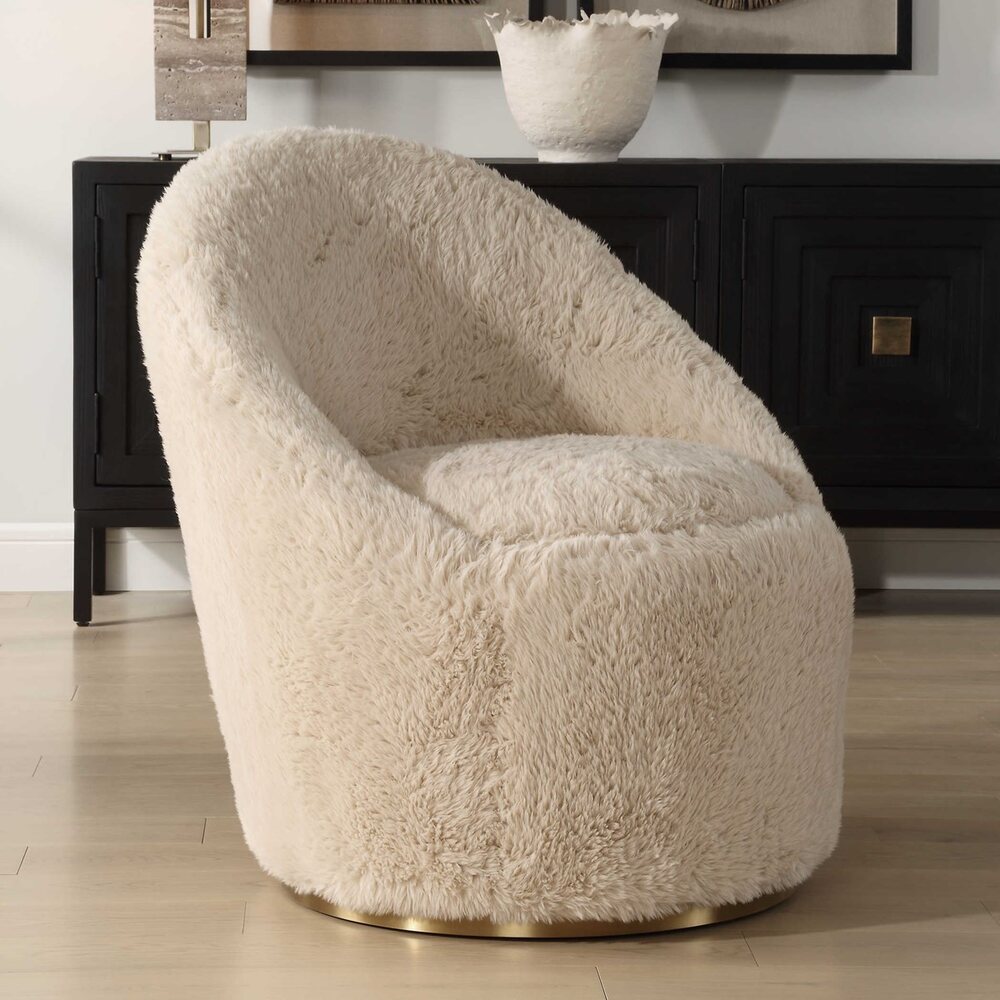 Luxurious accent chair with a warm caramel tone, fluffy faux sheepskin, and a sturdy swivel brass base.