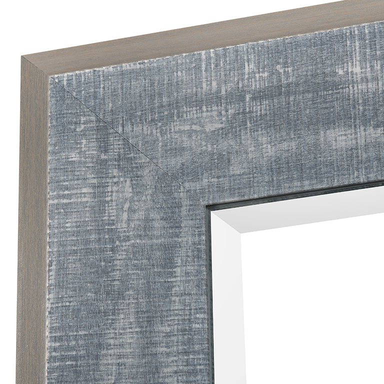 Close-up of a textured gray frame corner with a mirror.