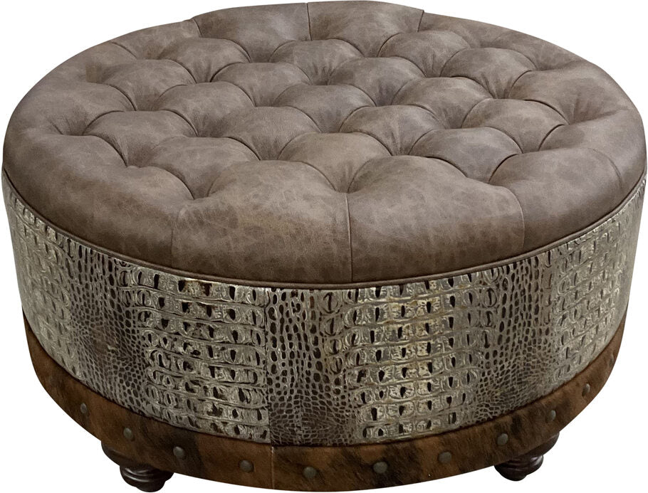 Close-up view of the Marshland Round Ottoman, showcasing the hand-tufted Palio Rum leather cushion for a luxurious and elegant finish.