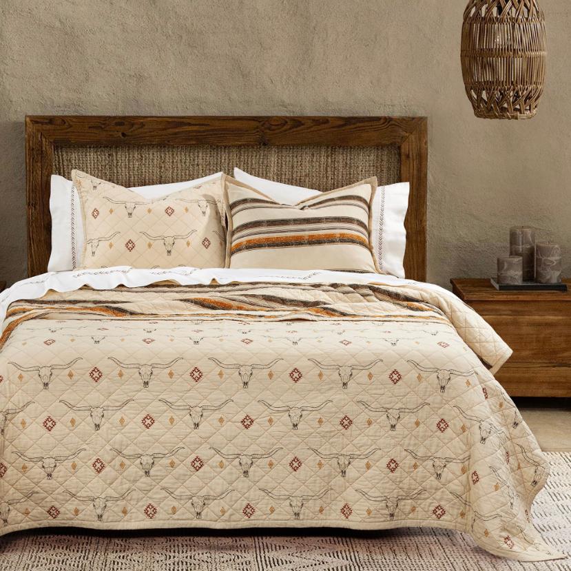 The quilt set styled in a rustic bedroom setting, complemented by wooden furniture and Western-themed décor.