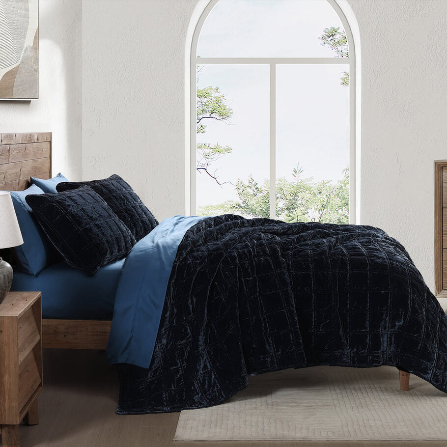 Midnight Blue Faux Silk Velvet Quilt Set styled in a contemporary bedroom, complementing neutral tones and minimalist décor.