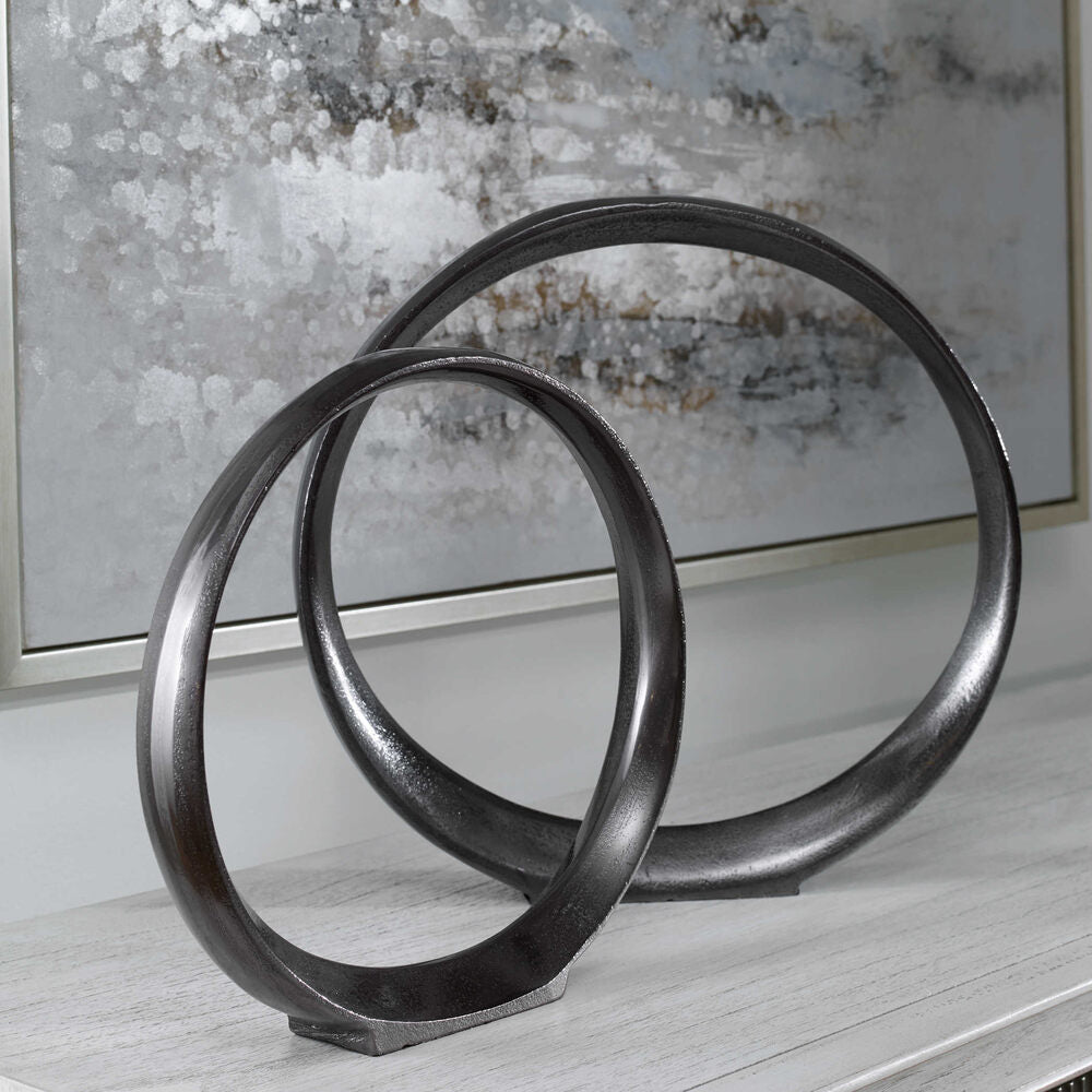 Stylish aluminum Loop Ring Sculpture with a sleek black nickel finish and unique design.