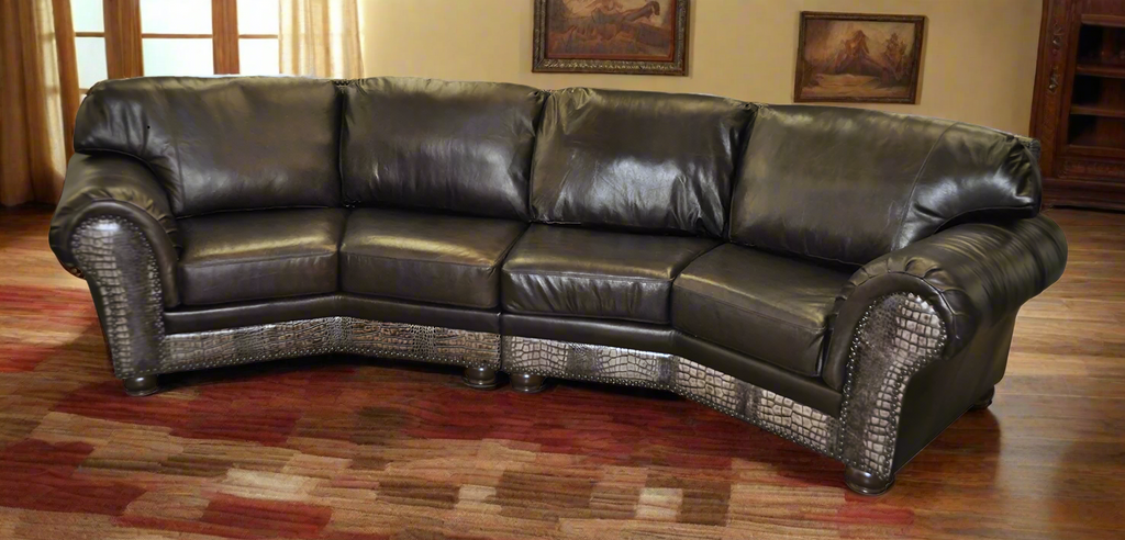 Brown leather sectional sofa with croc embossed leather on front arm posts and rail on a white background on wooden floor with art in background