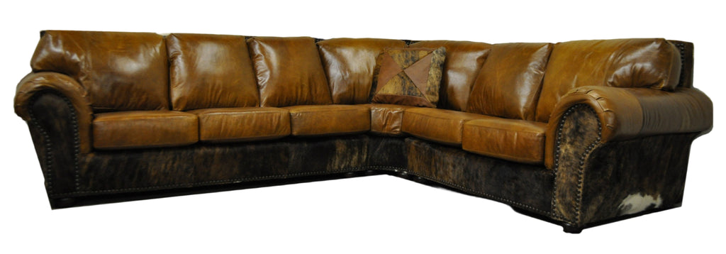 Brown leather sectional sofa with three seats, a pie section that connects to a two seat loveseat with cowhide accents on front arm panel, sides and back on a white background