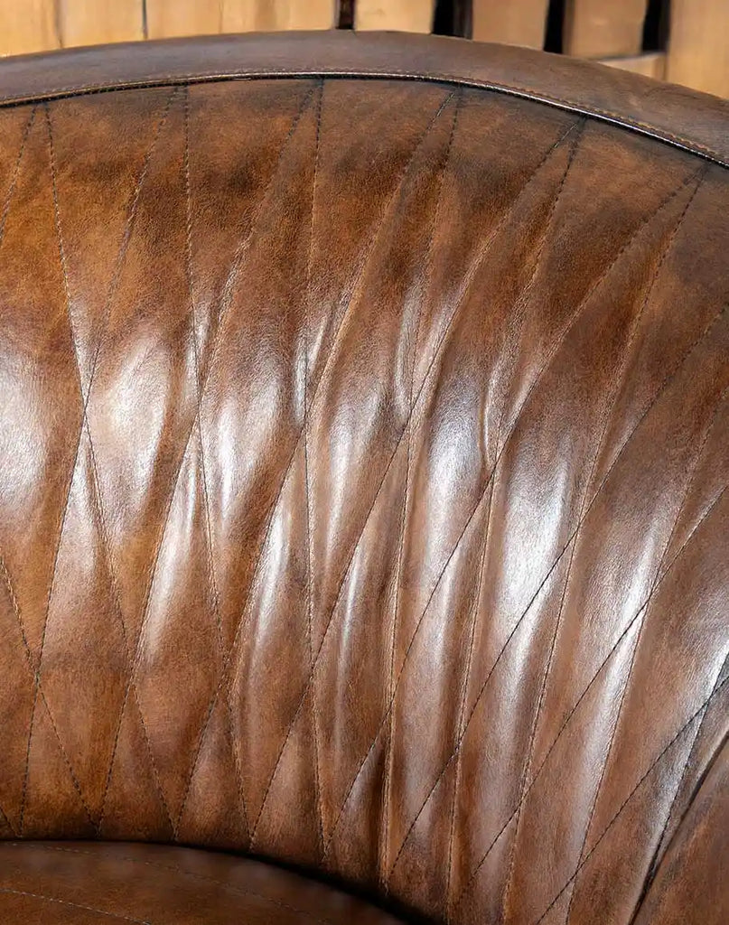 A detailed view of the sculpted backrest on the Moscow Mocha Swivel Chair, designed for lumbar support and relaxation.