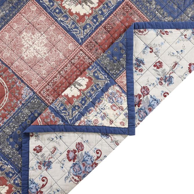 Close-up of the quilt's corner, displaying the precise stitching and the soft texture of the cotton fabric.
