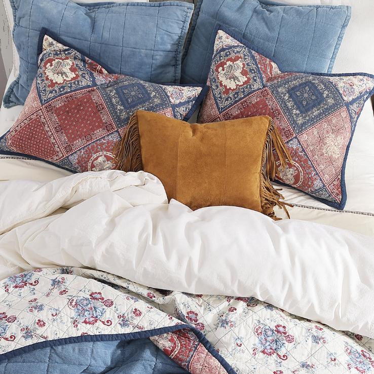 Detailed view of the matching pillow shams included in the set, displaying the coordinated bandana patchwork design.