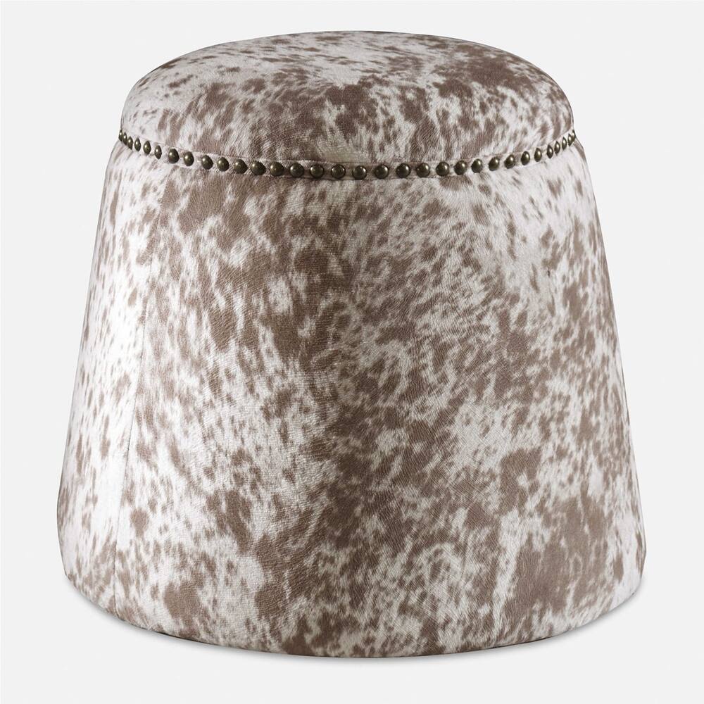 Plush ottoman with a luxurious faux cowhide cover and elegant brass nailhead details.