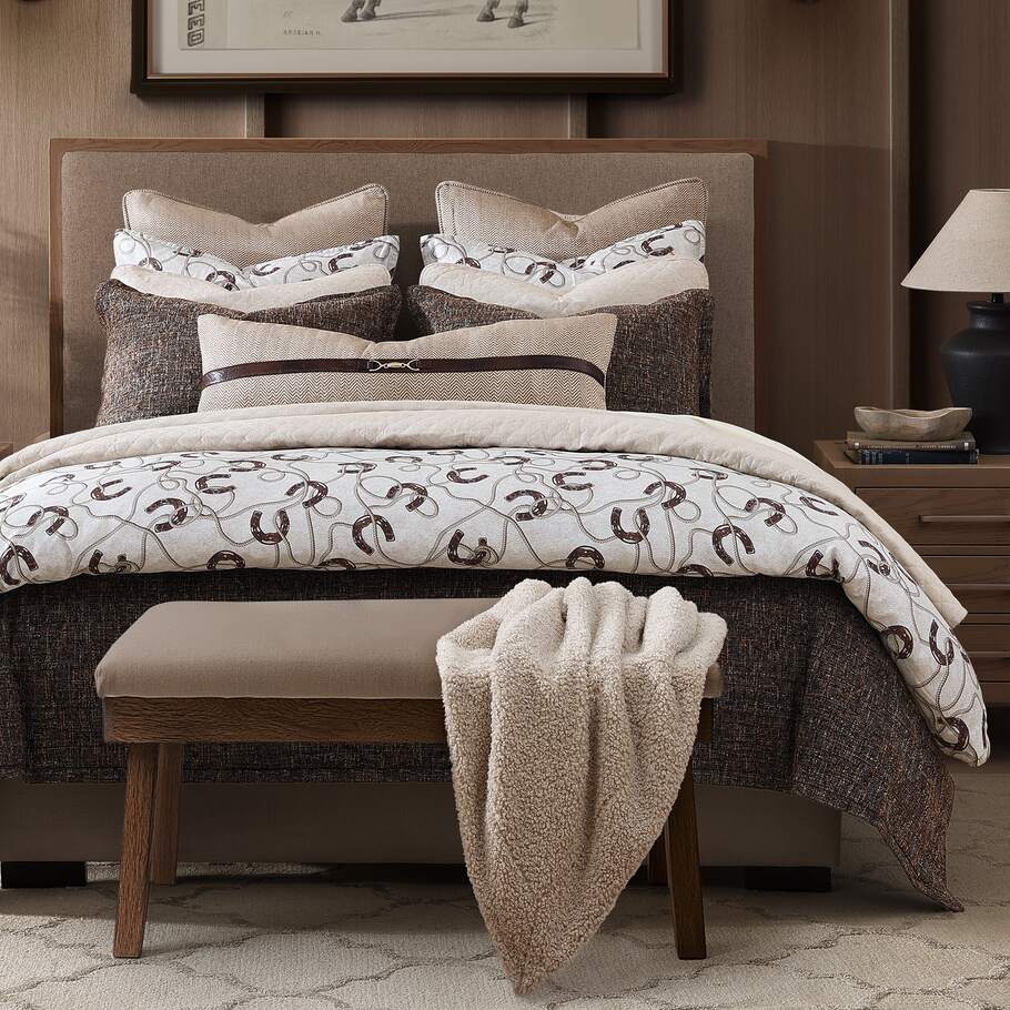Full view of the Prieto Equestrian Cotton Sateen Bedding Set, showcasing the comforter and matching shams with horseshoe and rope motifs in brown and tan on a cream background.