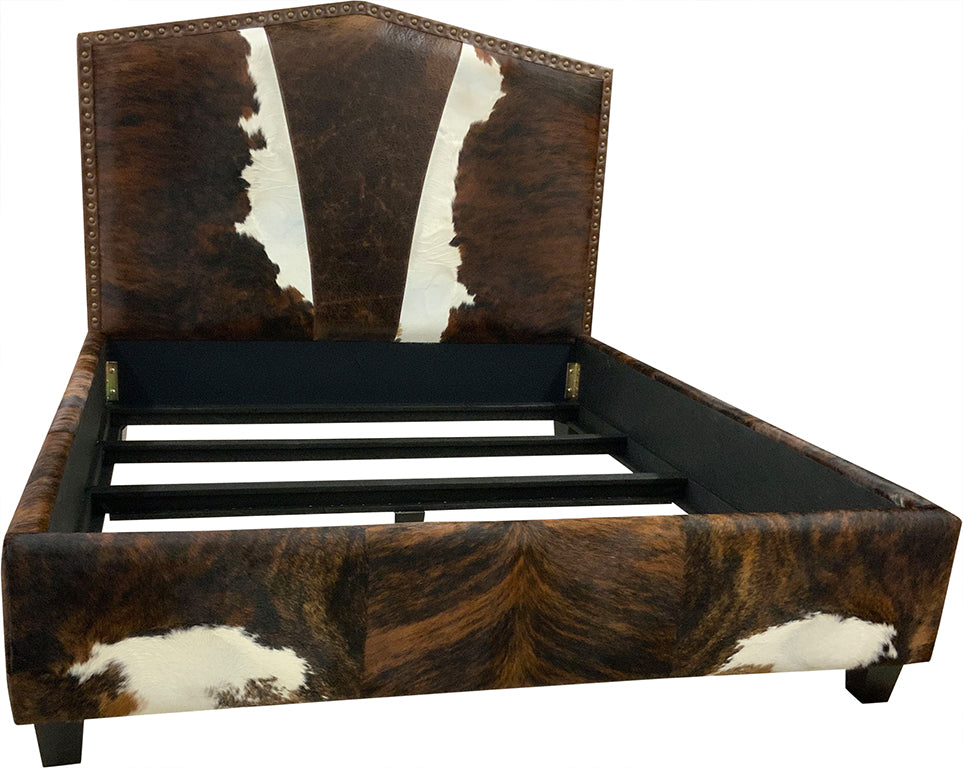 Bed with cowhide leather headboard, footboard, and side rails on a white background