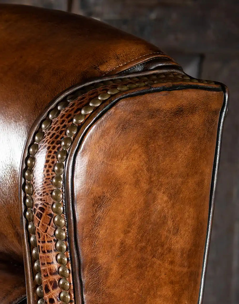Image focusing on the high-quality brass buttons on the base and wings of the Rancher Executive Desk Chair.