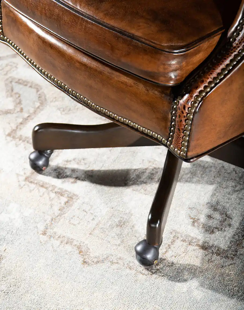 Detailed view of the base of the Rancher Executive Desk Chair, highlighting its solid mahogany construction and stability.