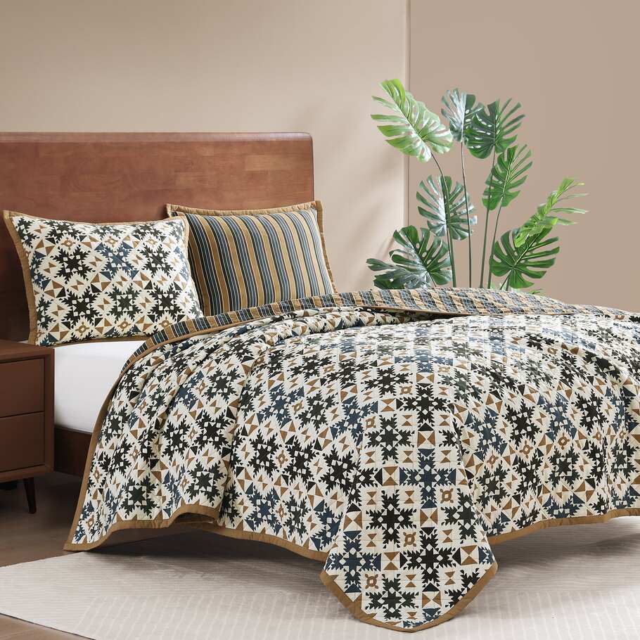 Ravenna Reversible Quilt Set featured in a modern bedroom setup, demonstrating its adaptability to contemporary interiors.