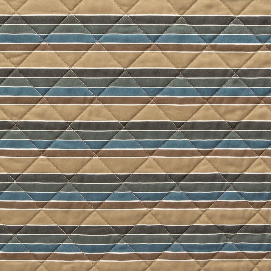 Image displaying the reverse side of the Ravenna Quilt, featuring a subtle running stripe design for a different look.​