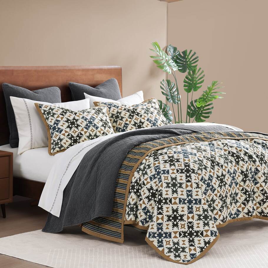 Ravenna Reversible Quilt Set offering a modern rustic aesthetic with intricate patchwork and versatile styling options.