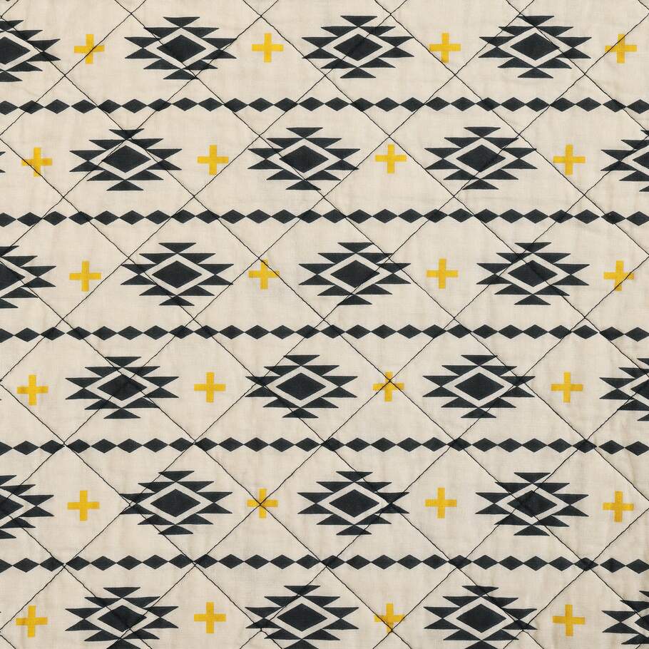 Image displaying the lighter reverse side of the Sonoran Desert Quilt, featuring smaller Southwestern motifs for a subtle look.