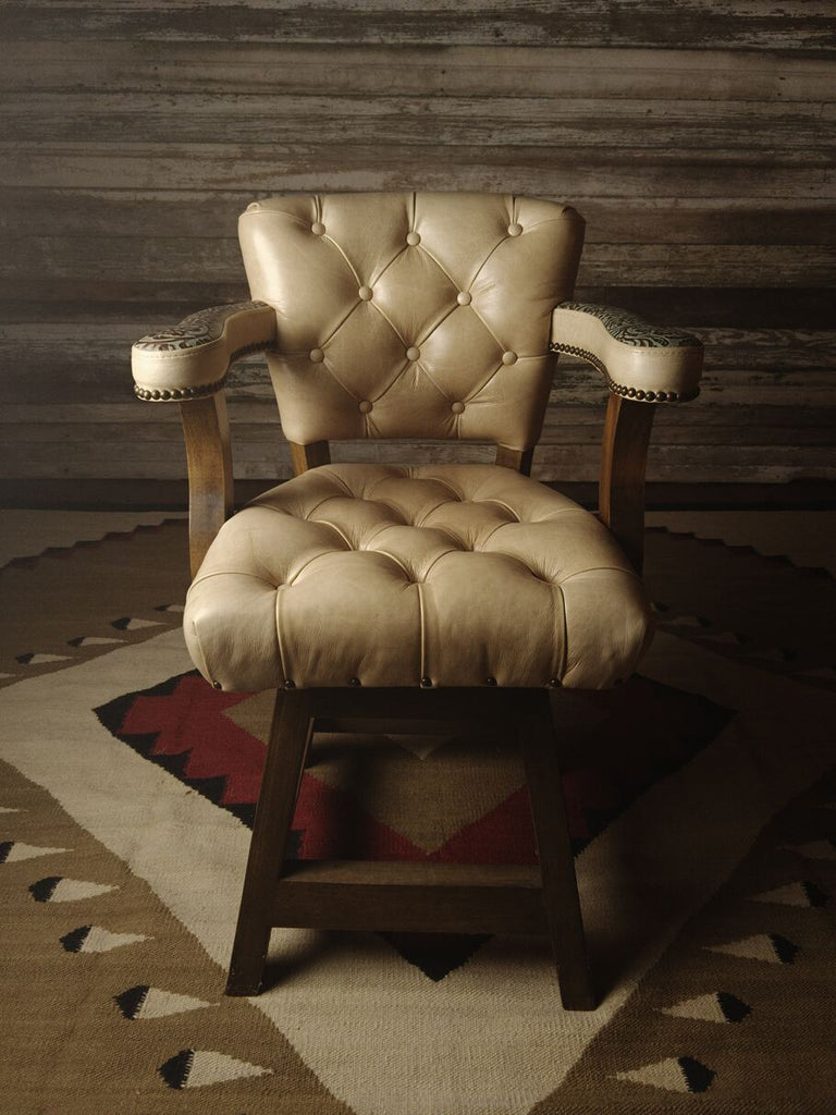 Front view of the Rio Grande Tufted Barstool showcasing Longhorn Oatmeal leather upholstery with tufted detailing and Floral River Reed accent leather on the arms and back.