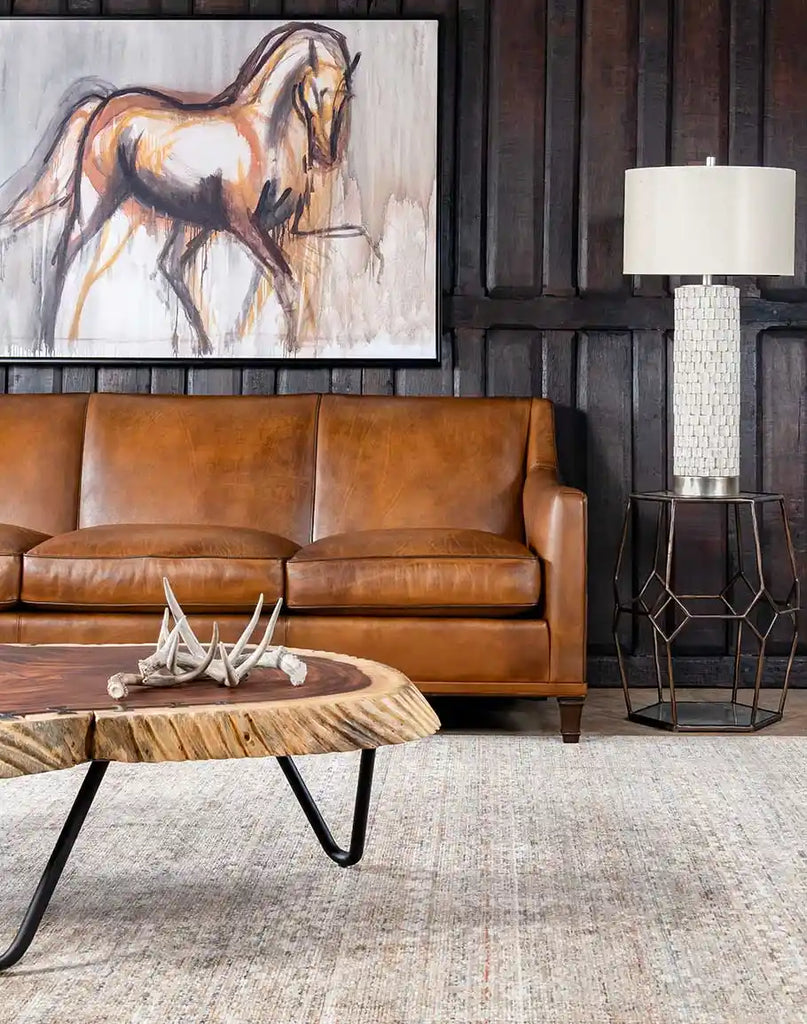 The Rudy Saddle Leather Sofa placed in a living room setting, complementing rustic western décor.