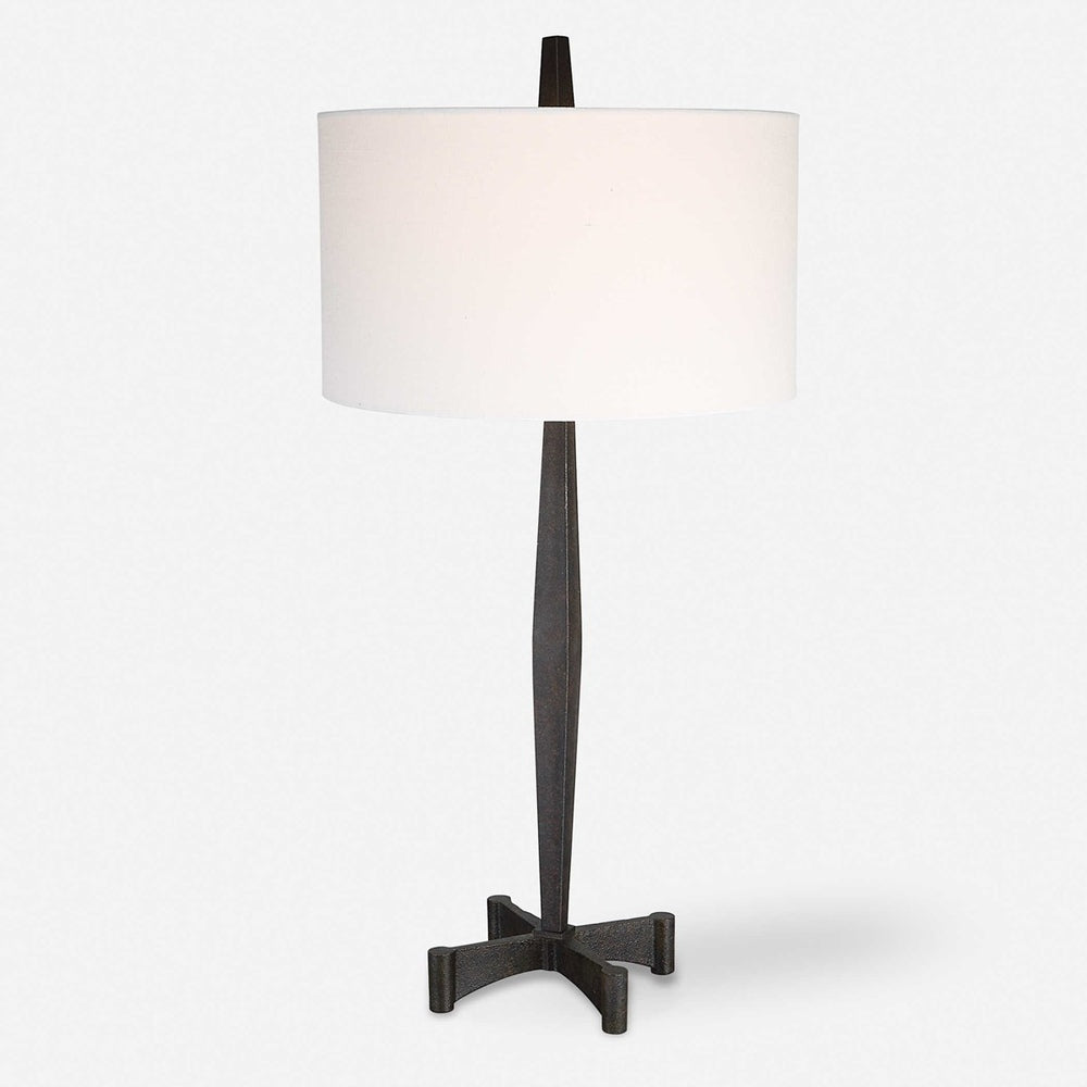 Stylish black table lamp with a tapered base, rust accents, and metalworking craftsmanship.