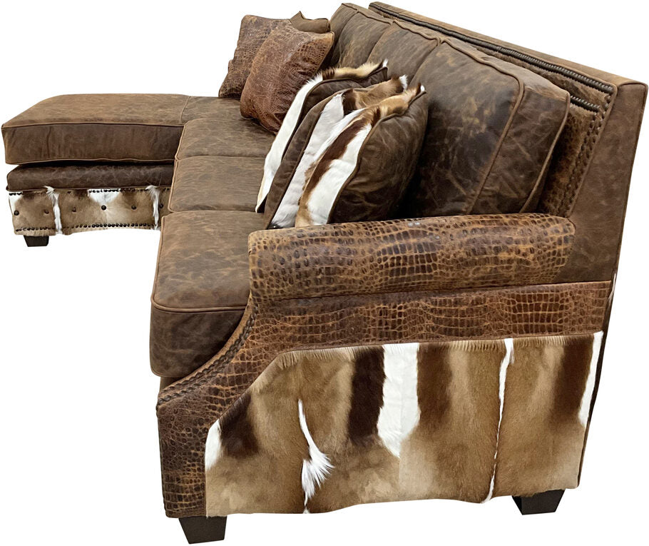 Close-up shot of the Sanaa Springbok Sectional Sofa's rolled armrest, showcasing Gator Hornback Rustic Cognac leather and intricate craftsmanship.