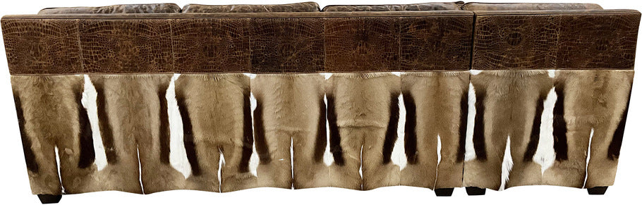 Back view of the Sanaa Springbok Sectional Sofa featuring Springbok hides adorning the back panel, complemented by Cora Pecan oil-finished leather.